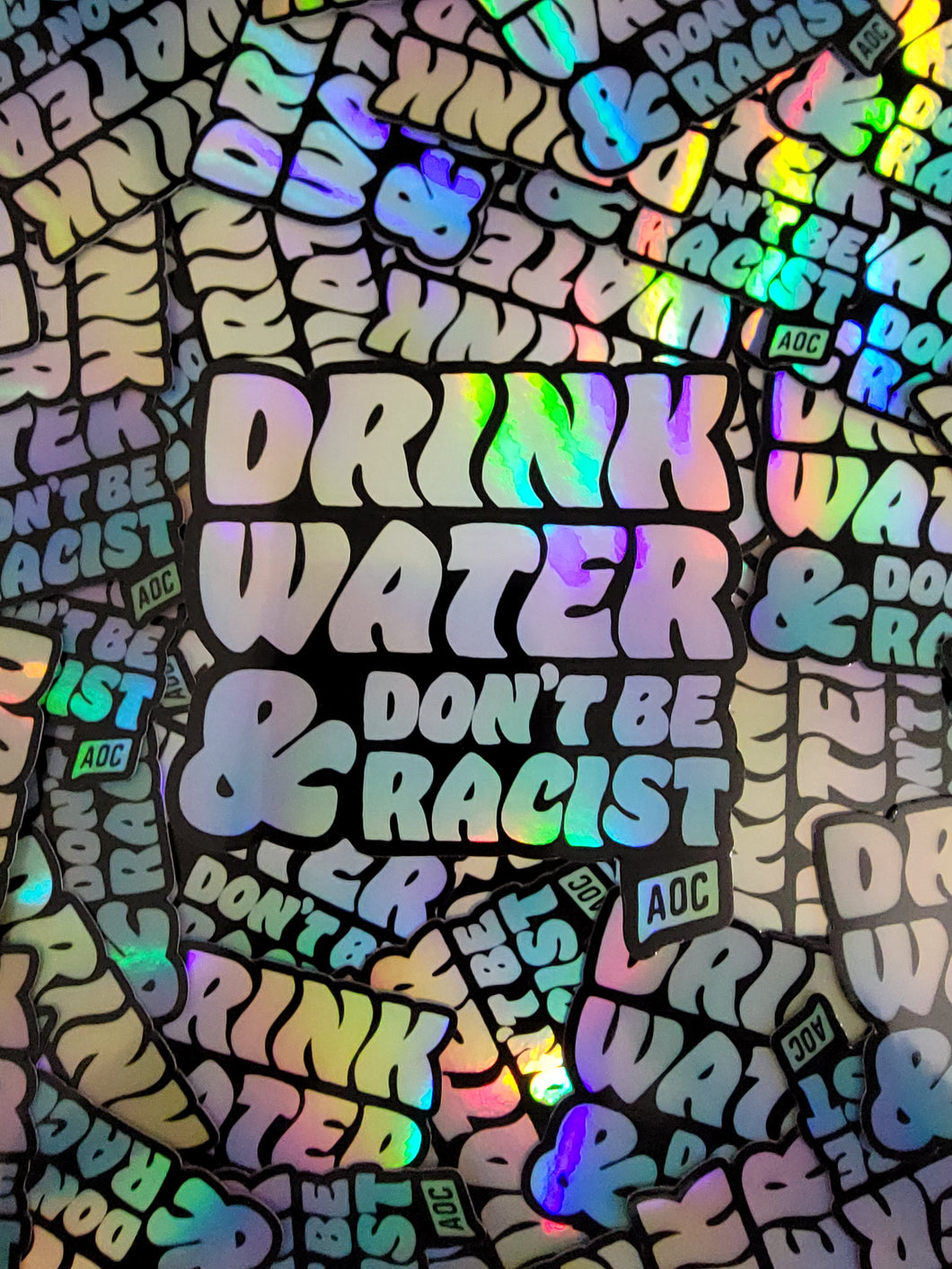 Holographic Drink Water & Don’t Be Racist AOC Sticker